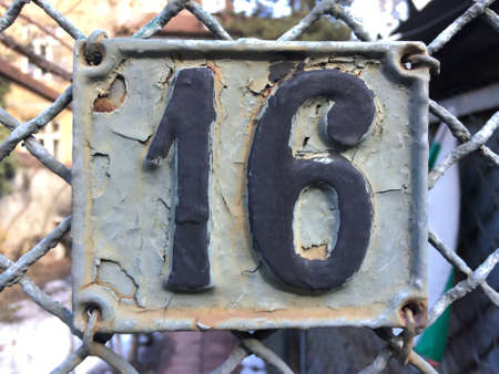 Vintage grunge square metal rusty plate of number of street addressの素材