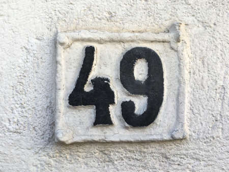 Vintage grunge square metal rusty plate of number of street addressの素材