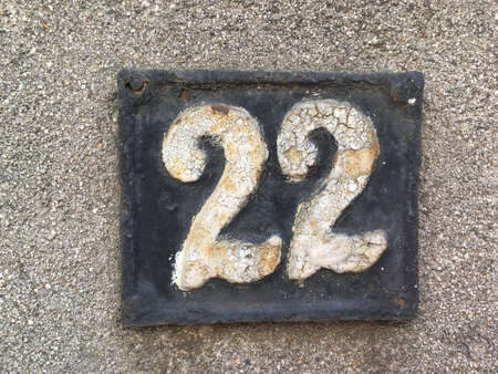 Vintage grunge square metal rusty plate of number of street addressの素材