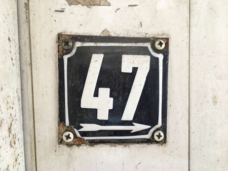 Vintage grunge square metal rusty plate of number of street addressの素材