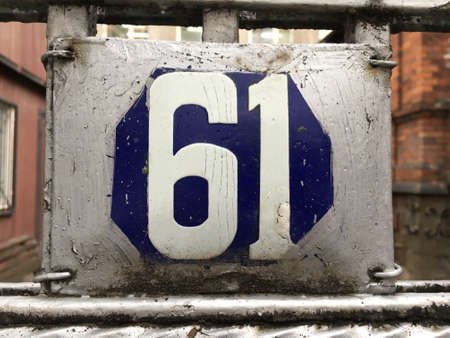 Vintage grunge square metal rusty plate of number of street addressの素材