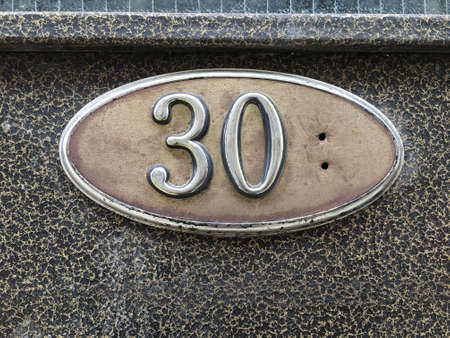 Vintage grunge square metal rusty plate of number of street addressの素材