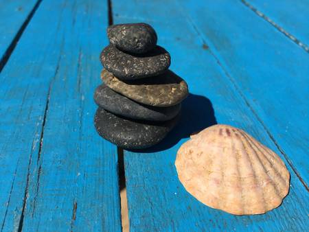 Set of stones put together to balance each other on a blue background