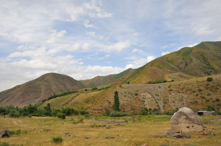Small kyrgyz poor jurt in mountains and blue skyの写真素材