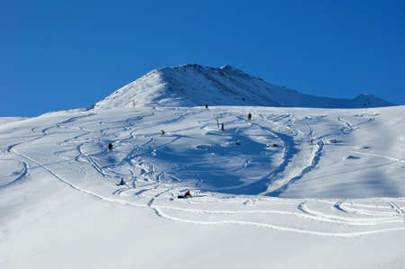 Winter, snowcapped mountains, ski resort and blue skyの写真素材