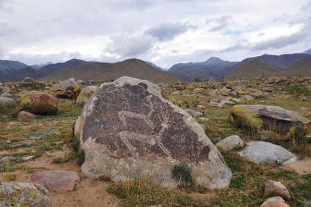 Ancient petroglyph on stones in mountains of Kyrgyzstanの写真素材