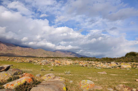 Big stones in Kyrgyz mountains and perfect cloudsの写真素材