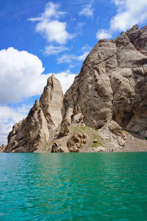 Amazing Kelsu mountain lake between the stunned rocks and blue sky with clouds - Kelsu, Kyrgyzstanの写真素材
