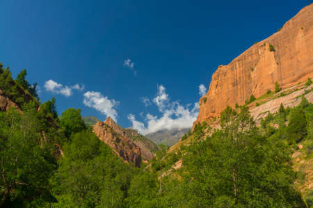 Mountains, rocks, blue sky and green vegetation in Kozhokelenの写真素材
