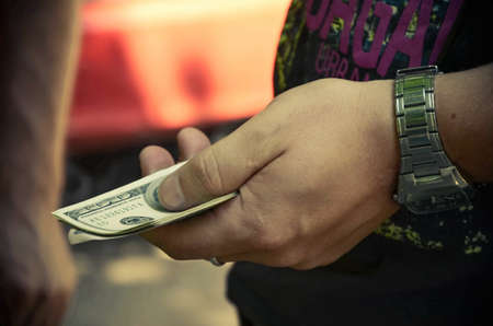 hand holding a stack of moneyの写真素材