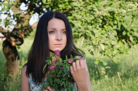 Young girl holding clover bouquetの写真素材
