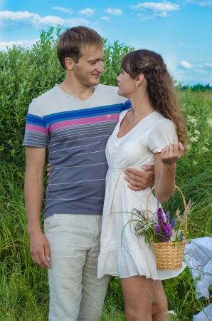 Young loving couple embracing  and smiling in the fieldの写真素材
