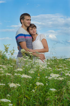 Young beautiful couple embracing  each other in the fieldの写真素材