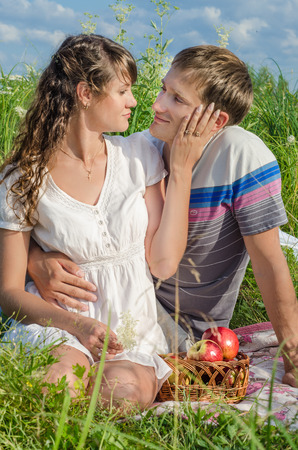 Romantic young couple resting outdoors and tenderlt touching each otherの写真素材