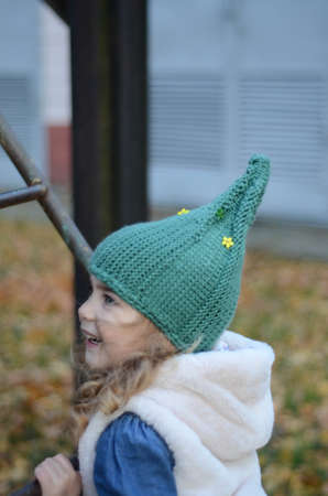 Picture of a blonde toddler girl in the funny knitted hatの写真素材
