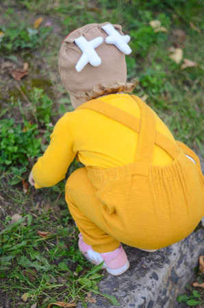 Photo of a blue-eyed toddler girl playing outside on the playgroundの写真素材