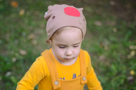 Photo of a blue-eyed toddler girl playing outside on the playgroundの写真素材