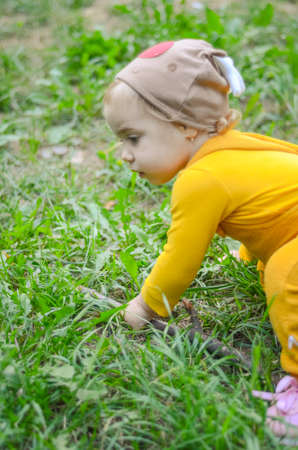 Photo of a blue-eyed toddler girl playing outside on the playgroundの写真素材
