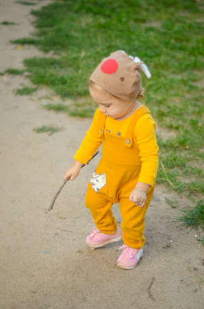 Photo of a blue-eyed toddler girl playing outside on the playground