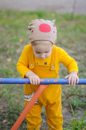 Photo of a blue-eyed toddler girl playing outside on the playgroundの写真素材