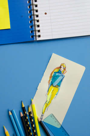 Flatlay empty space dark blue cover Stripe Notepad on a blue background vertical fashion sketch of...