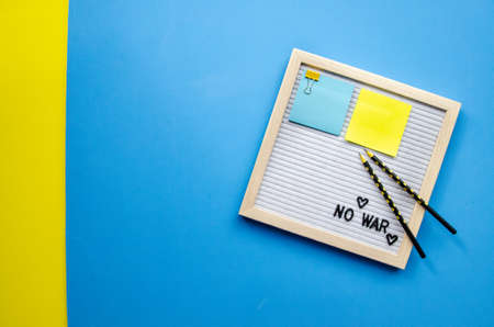 Flatlay horizontal composition empty letter board with the words No War, pray for Ukraine, patriotic...