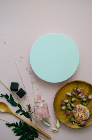 Close-up vertical Flat Lay SPA objects in a Wooden plates: sea salt, wooden spoons, white and pink shells, rose flowers buds and leaves, vertical white round mockup space forの写真素材