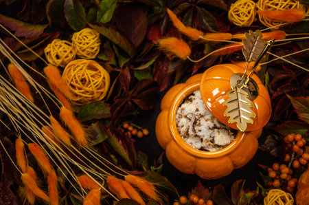 Thanksgiving vertical Autumn festive table background with pumpkin top view branches of sea buckthorn berries a pumpkin-shaped pot with sponge cake surrounded by dried flowersの写真素材