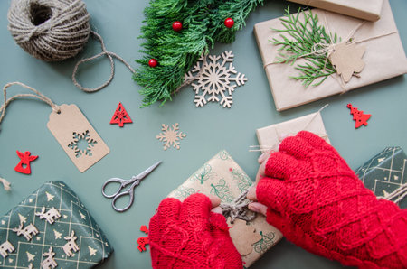 Santa Claus wrapping Christmas gift. Merry Christmas concept, Top view of Santa claus hands wrapping a craft gift box.の写真素材