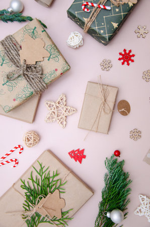 Eco friendly Christmas composition with gift boxes in craft reusable paper and natural decor on white background top view. Zero waste environmentally friendly Christmas concept.の写真素材