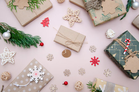 Eco friendly Christmas composition with gift boxes in craft reusable paper and natural decor on...