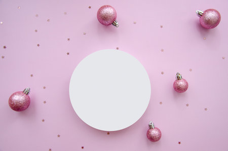 Christmas composition. Pink decorations on pastel pink background. Christmas, winter, new year concept. Flat lay, top view, copy space, round mock up.の写真素材