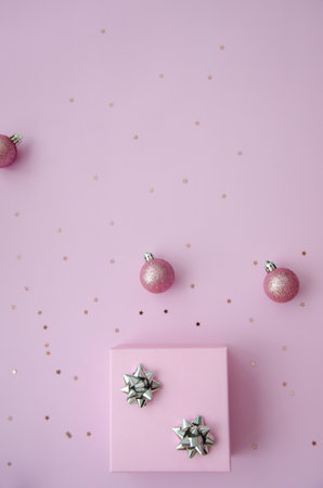 Christmas composition. A pattern of christmas pink balls, gift box and glitter on deep pink
 background. Flat lay, top view New year decor. Copy space.の写真素材