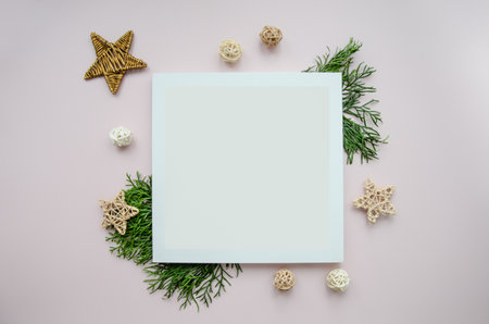 Christmas minimal concept - christmas composition made of evergreen tree branch, craft wicker stars and balls. new year composition. Flat lay, top view. White frame with copy space. design template.の写真素材