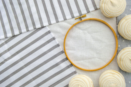 Meringue homemade zephyr marshmallows with round embroidery hoop frame on cotton tablecloth. mockup card. Template for recipes, food menu, craftの写真素材