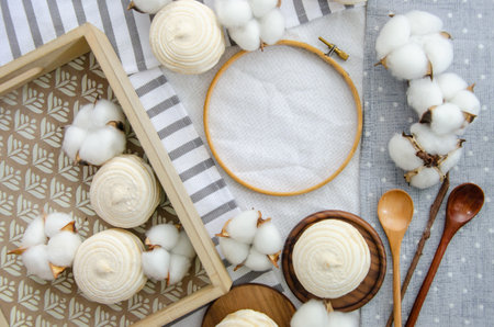 Round hoop frame, meringue homemade zephyr in wooden tray, wooden spoons and cotton buds. mockup card. Template for recipes, food menu, craftの写真素材
