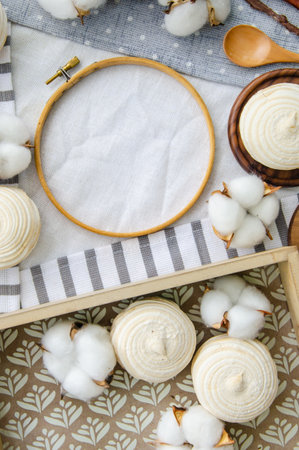 Round hoop frame, meringue homemade zephyr in wooden tray, wooden spoons and cotton buds. mockup card. Template for recipes, food menu, craftの写真素材