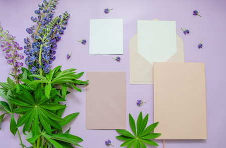 Lupine flowers bouquet on a purple background, notebook, envelope, blank card and note paper. summer background. text space.の写真素材