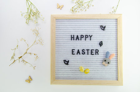 Easter composition with letter board, dried flowers, decorations on grey background, minimalistic styleの写真素材