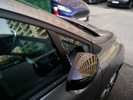 a broken triangular window from my car. they tried to steal my radioの写真素材
