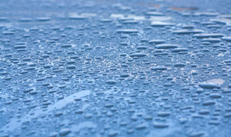 water drops on the roof of a blue carの写真素材