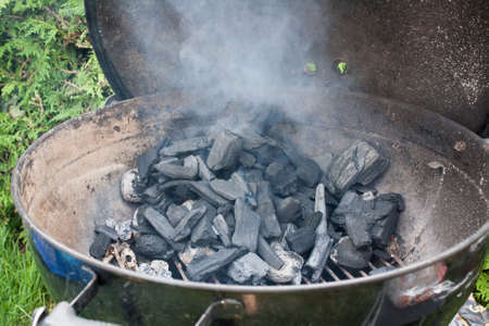 ignite some briquettes to turn on the barbecueの写真素材