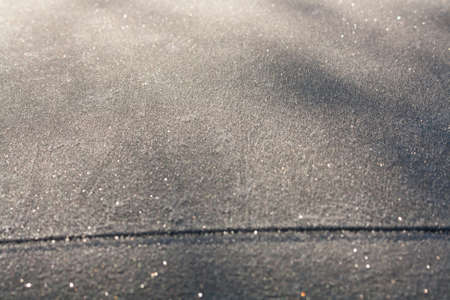 Frozen car roof in the morning sunの写真素材