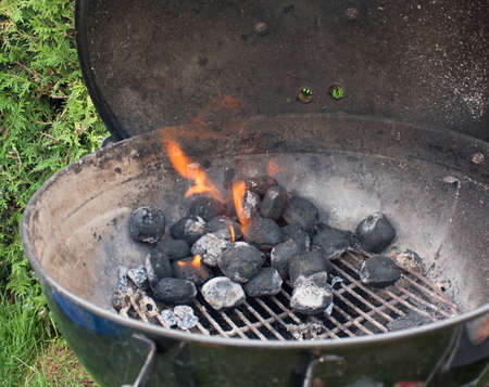 ignite some briquettes to turn on the barbecueの写真素材