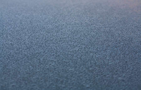 water drops on the roof of a gray carの写真素材