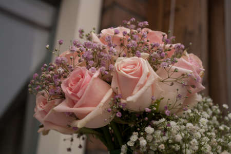 wedding bouquet with pink roses waiting to be picked up by the brideの写真素材