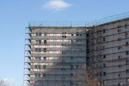 construction scaffolding standing on the side of a buildingの写真素材