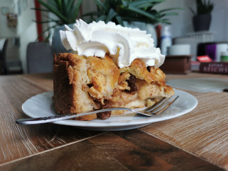Dutch apple pie, baked following grandma's recipe, getting some whipped cream on top.の写真素材