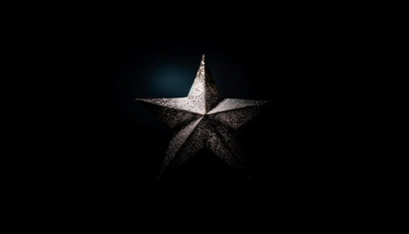 Golden star symbol shines on dark metallic background, luxury celebration generated by artificial intelligenceの素材