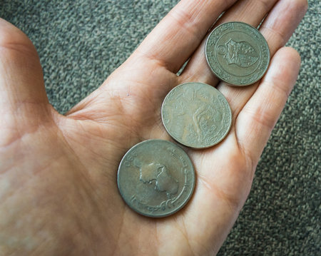 Three Tunisian coins on the woman's palm.の写真素材